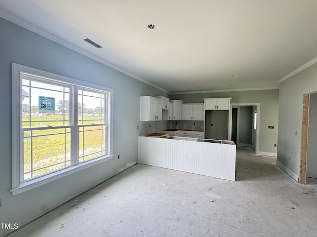 502 S Vance St, Fremont, NC 27830 - kitchen with ornamental molding, white cabinetry, a center island, and baseboards