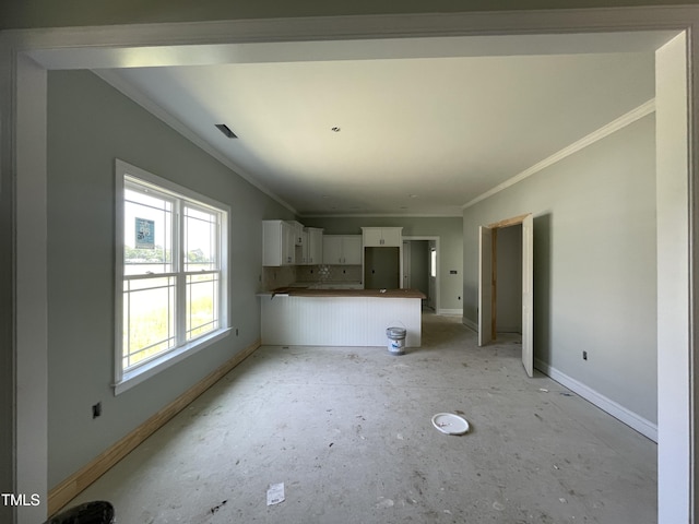 502 S Vance St, Fremont, NC 27830 - kitchen featuring baseboards, ornamental molding, white cabinetry, and a peninsula