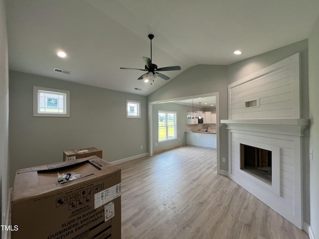 502 S Vance St, Fremont, NC 27830 - unfurnished living room with a ceiling fan, light wood finished floors, vaulted ceiling, a glass covered fireplace, and recessed lighting