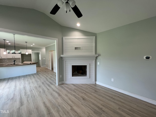 502 S Vance St, Fremont, NC 27830 - unfurnished living room with lofted ceiling, a ceiling fan, light wood-style floors, recessed lighting, and a fireplace