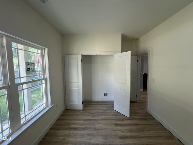 502 S Vance St, Fremont, NC 27830 - unfurnished bedroom with multiple windows, wood finished floors, and a closet