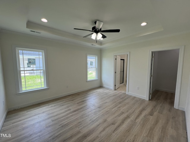 502 S Vance St, Fremont, NC 27830 - unfurnished bedroom with a raised ceiling, ornamental molding, light wood-style flooring, a spacious closet, and recessed lighting