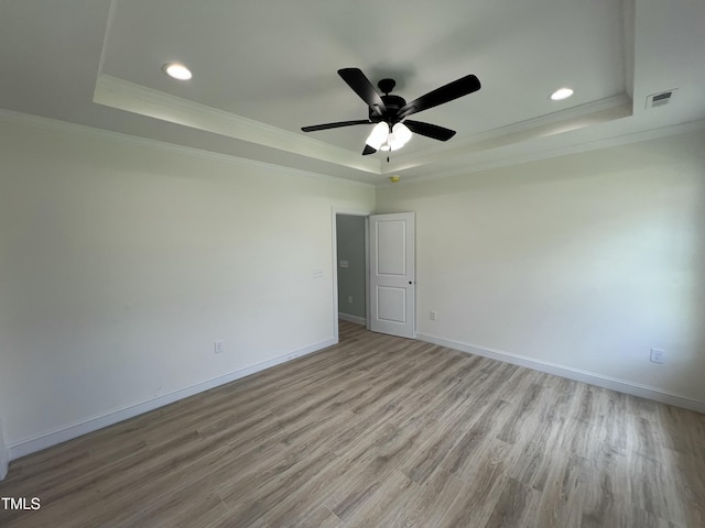 502 S Vance St, Fremont, NC 27830 - empty room with a tray ceiling, crown molding, recessed lighting, wood finished floors, and ceiling fan