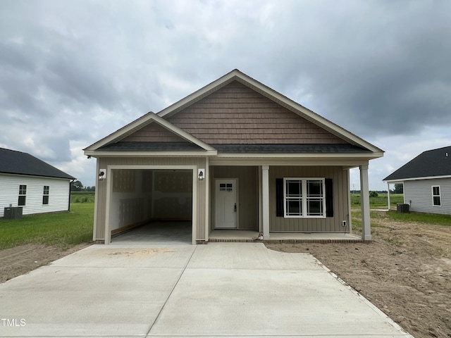 502 S Vance St, Fremont, NC 27830 - view of front of home featuring board and batten siding, concrete driveway, a porch, and an attached garage