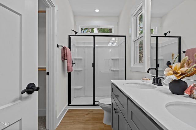 111 Halifax Rd, Louisburg, NC 27549 - bathroom featuring a sink, toilet, a shower stall, double vanity, and wood finished floors