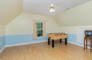2265 Bud Lipscomb Rd, Willow Springs, NC 27592 - rec room with wood finished floors, a ceiling fan, and vaulted ceiling