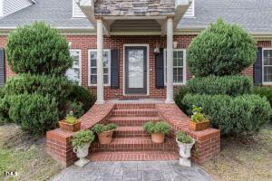 2265 Bud Lipscomb Rd, Willow Springs, NC 27592 - doorway to property featuring brick siding