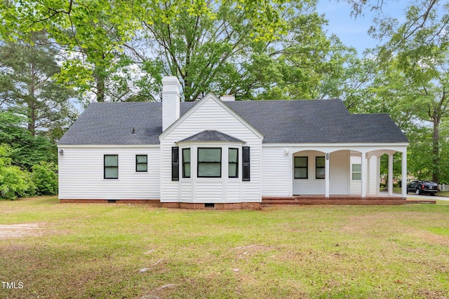 view of front facade featuring a front lawn, roof with shingles, covered porch, and crawl space