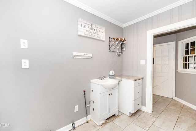 bathroom featuring vanity, ornamental molding, baseboards, and tile patterned floors