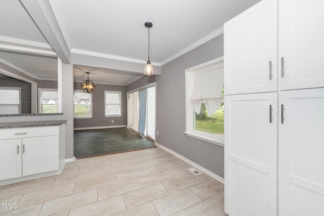 interior space with baseboards and ornamental molding