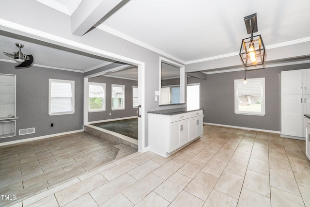kitchen with visible vents, ornamental molding, dark countertops, white cabinets, and a ceiling fan