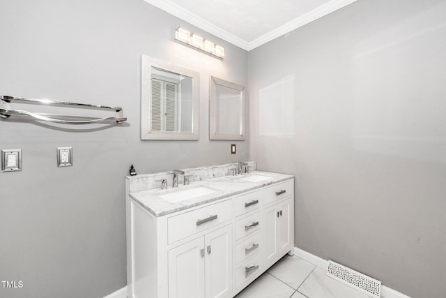 bathroom with a sink, baseboards, ornamental molding, and visible vents