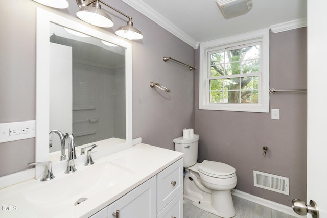 bathroom featuring visible vents, ornamental molding, vanity, toilet, and baseboards