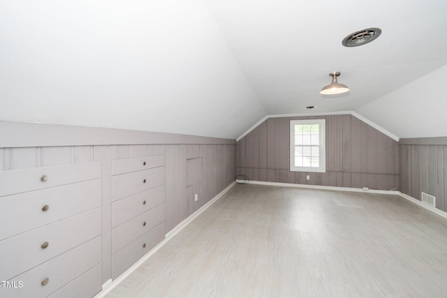 bonus room featuring visible vents, baseboards, and lofted ceiling