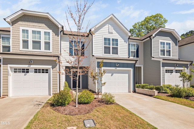 multi unit property with a garage, board and batten siding, and concrete driveway