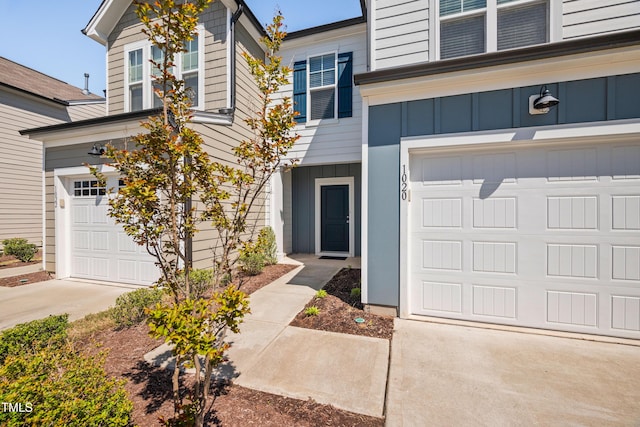 view of front of home featuring board and batten siding, a garage, and concrete driveway