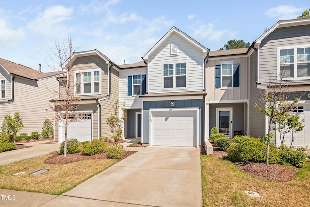 townhome / multi-family property featuring board and batten siding, a garage, and concrete driveway