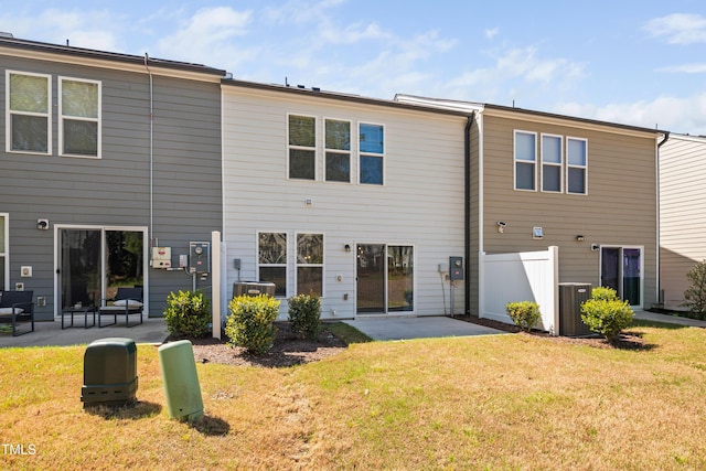 back of house with a patio, central air condition unit, and a lawn