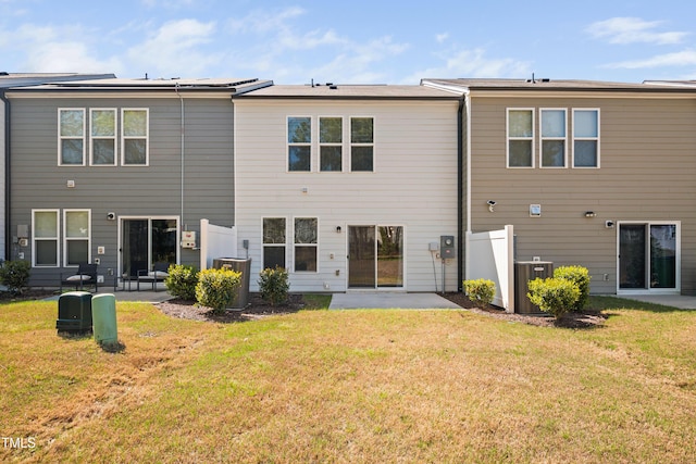 rear view of house with a patio area and a lawn