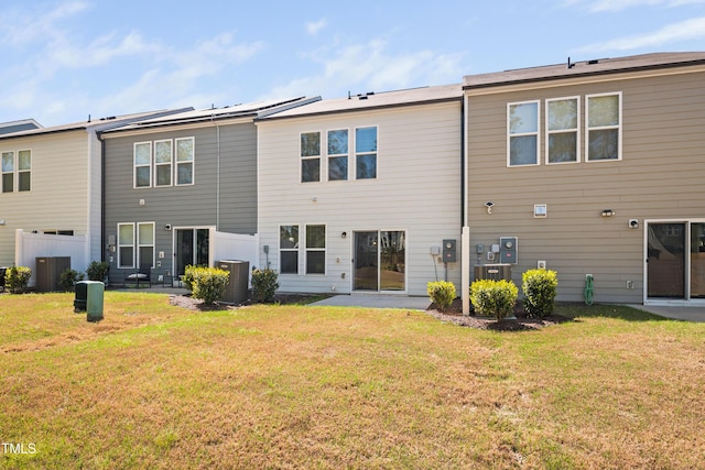 back of property featuring central AC unit, a yard, and a patio area