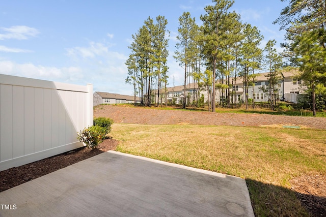 view of yard featuring a residential view and a patio