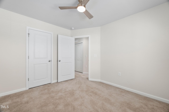 unfurnished bedroom with baseboards, ceiling fan, and carpet