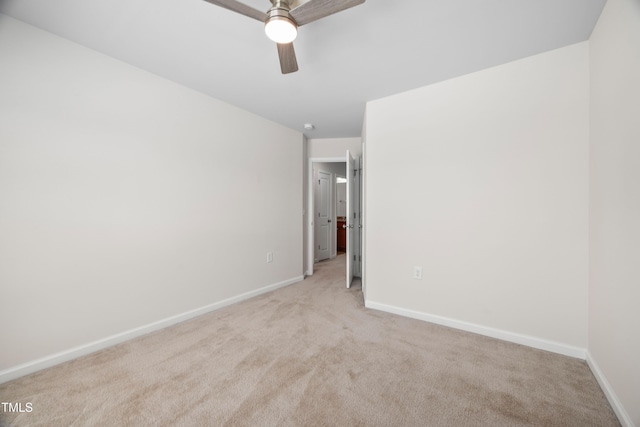 unfurnished bedroom with light carpet, ceiling fan, and baseboards