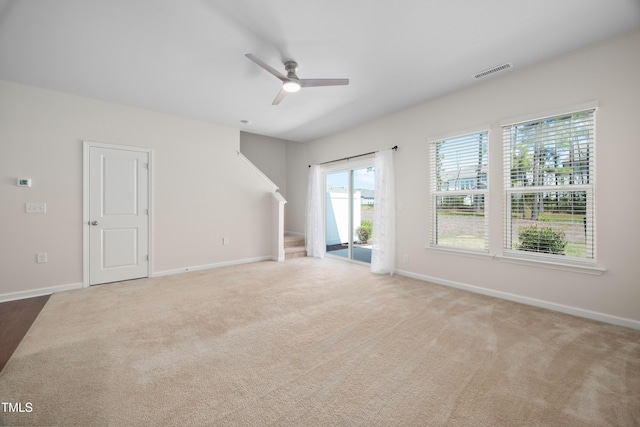 unfurnished living room featuring baseboards, a ceiling fan, visible vents, and carpet floors