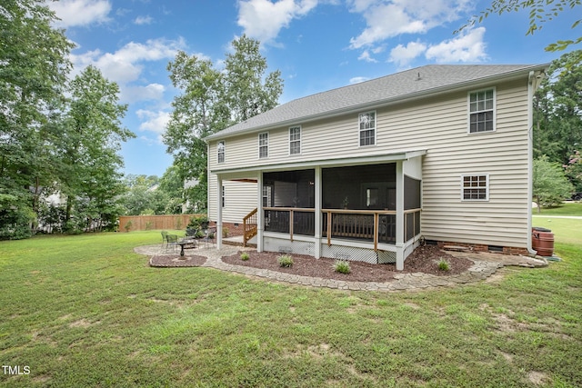 back of property featuring a sunroom, a yard, a patio area, crawl space, and fence