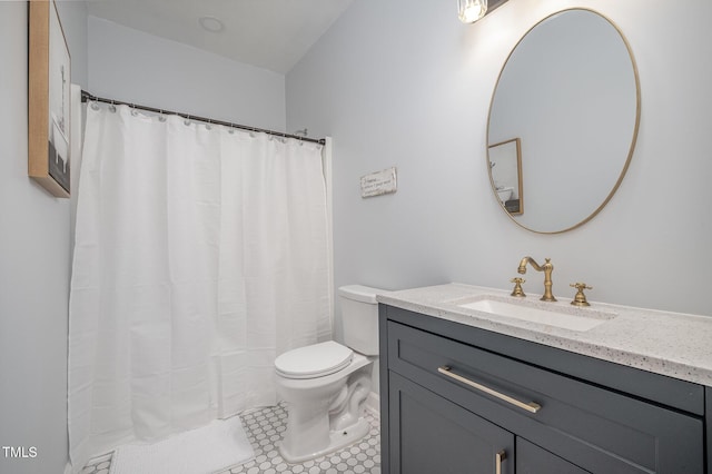 bathroom with tile patterned floors, toilet, curtained shower, and vanity