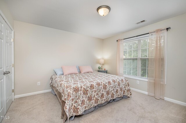 bedroom with visible vents, baseboards, and carpet floors
