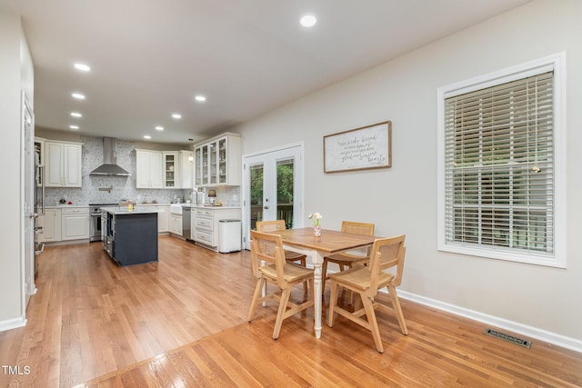 dining room featuring french doors, baseboards, recessed lighting, and light wood-style floors