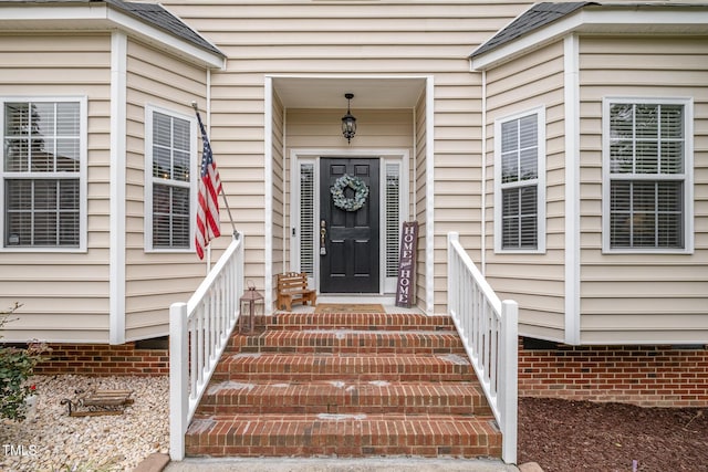 entrance to property with roof with shingles