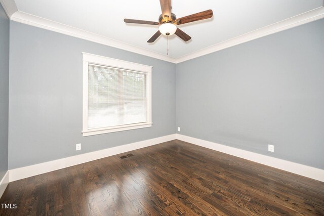 spare room featuring dark wood-type flooring, visible vents, crown molding, and a ceiling fan