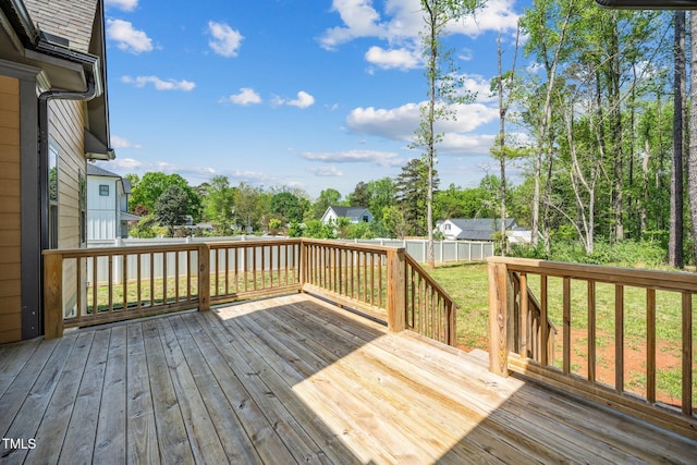 deck with a yard and fence