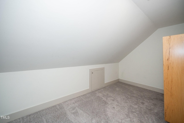 bonus room featuring carpet flooring, baseboards, and lofted ceiling