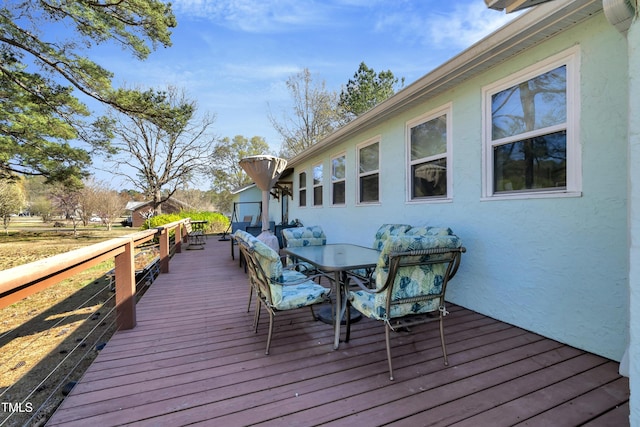 wooden terrace featuring outdoor dining space