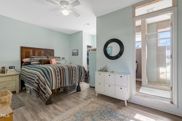 bedroom featuring light wood-style floors, visible vents, and ceiling fan