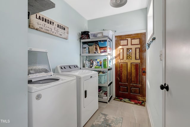 washroom featuring washing machine and clothes dryer and laundry area