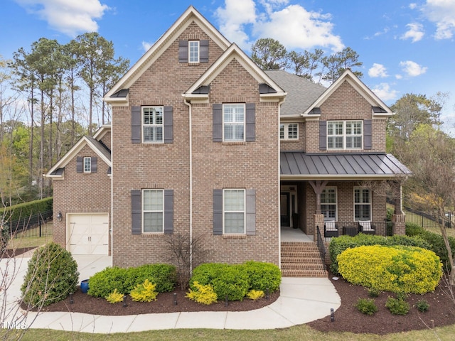 5928 Terrington Ln, Raleigh, NC 27606 - craftsman-style house featuring a standing seam roof, covered porch, metal roof, brick siding, and a garage