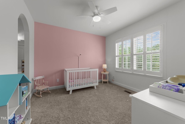 5928 Terrington Ln, Raleigh, NC 27606 - carpeted bedroom with ceiling fan, arched walkways, visible vents, a crib, and baseboards