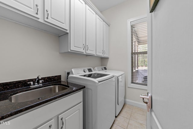 5928 Terrington Ln, Raleigh, NC 27606 - clothes washing area featuring baseboards, a sink, light tile patterned flooring, cabinet space, and washing machine and clothes dryer