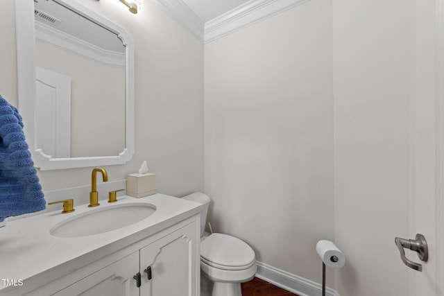5928 Terrington Ln, Raleigh, NC 27606 - half bathroom featuring vanity, baseboards, crown molding, toilet, and visible vents