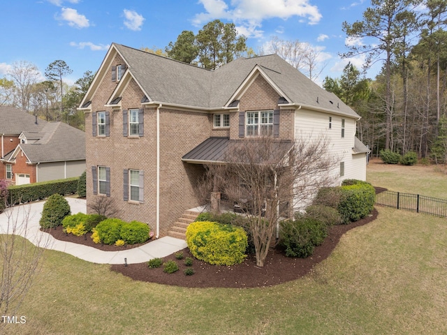 5928 Terrington Ln, Raleigh, NC 27606 - view of front facade with a standing seam roof, brick siding, fence, and a front lawn