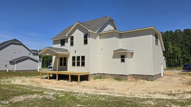 back of house with roof with shingles, a deck, and crawl space
