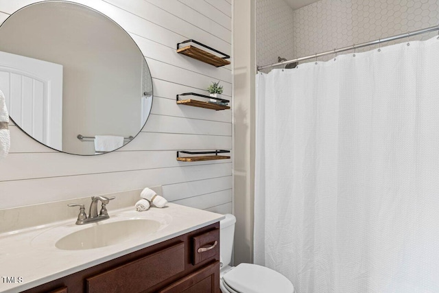 bathroom featuring toilet, wooden walls, vanity, and a shower with curtain