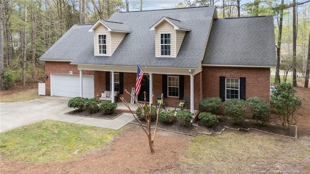 887 Thrush Dr, Vass, NC 28394 - new england style home with a porch, brick siding, concrete driveway, an attached garage, and a shingled roof