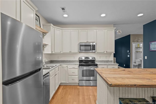 887 Thrush Dr, Vass, NC 28394 - kitchen featuring visible vents, appliances with stainless steel finishes, wooden counters, and light wood-type flooring
