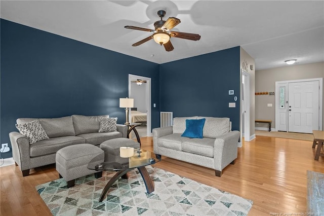 887 Thrush Dr, Vass, NC 28394 - living area with baseboards, light wood finished floors, and ceiling fan