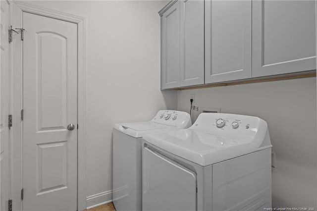 887 Thrush Dr, Vass, NC 28394 - laundry room featuring independent washer and dryer and cabinet space